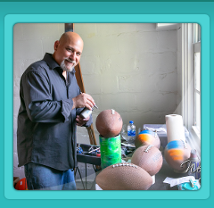 Fester airbrushing a football at a Bar Mitzvah